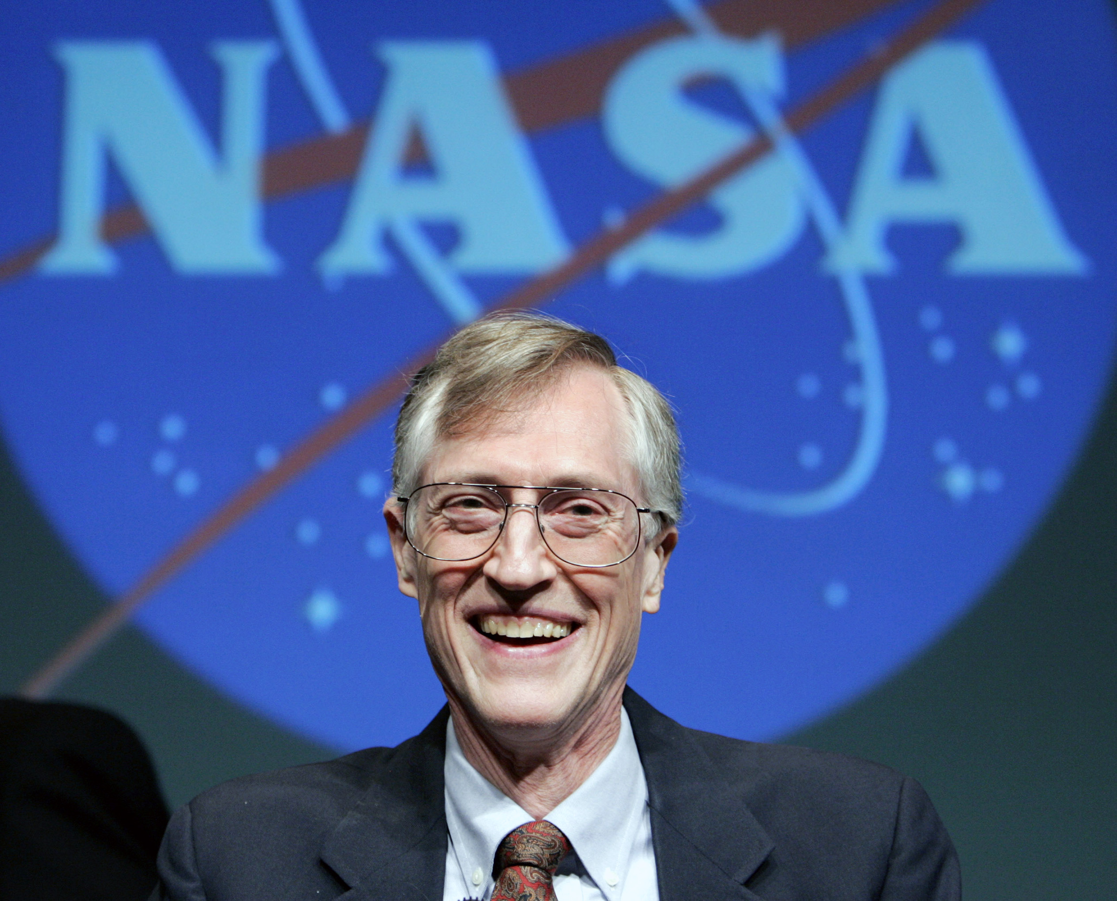 At NASA Headquarters in Washington, D.C., John Mather takes questions from the press after receiving word he has won the 2006 Nobel Prize in Physics. Mather's studies of cosmic radiation helped determine the age of the universe and have added weight to the Big Bang theory of its origin. (© Larry Downing/Reuters/CORBIS)