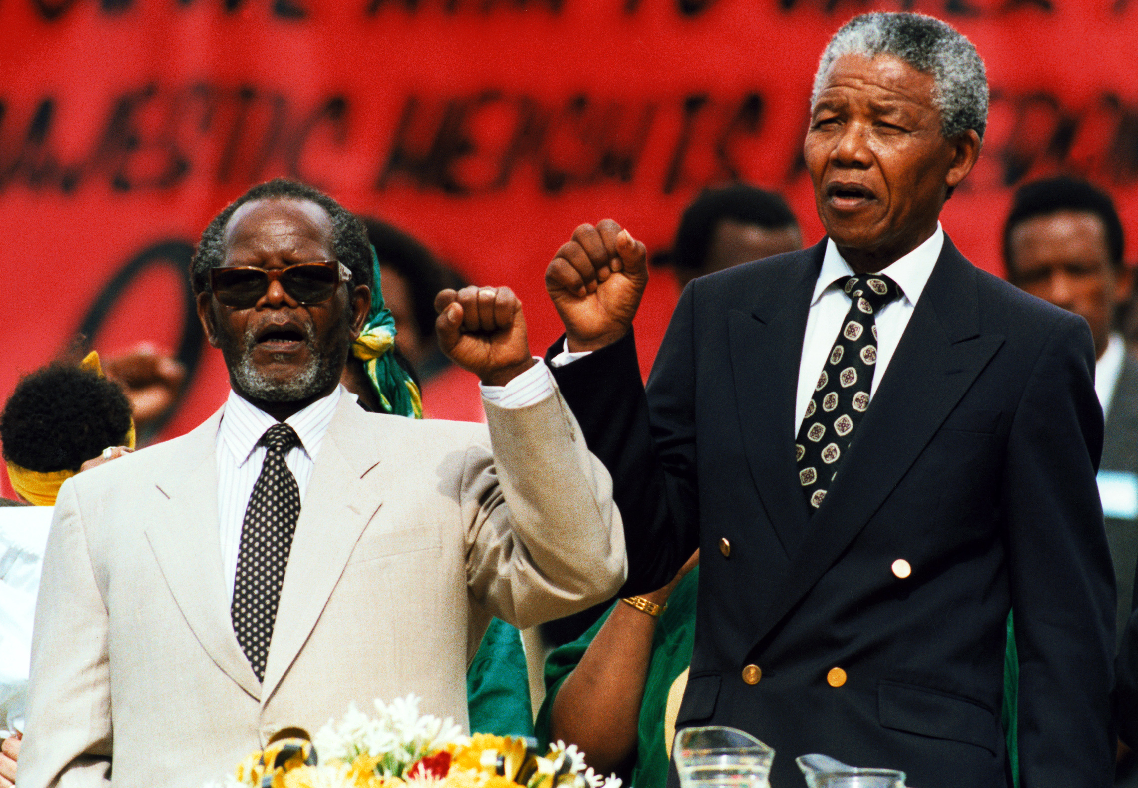 ANC President Oliver Tambo and Deputy President Nelson Mandela sing the party's anthem at a rally in Johannesburg, following Mandela's release from prison and Tambo's return from 30 years of exile. (© Reuters/CORBIS)