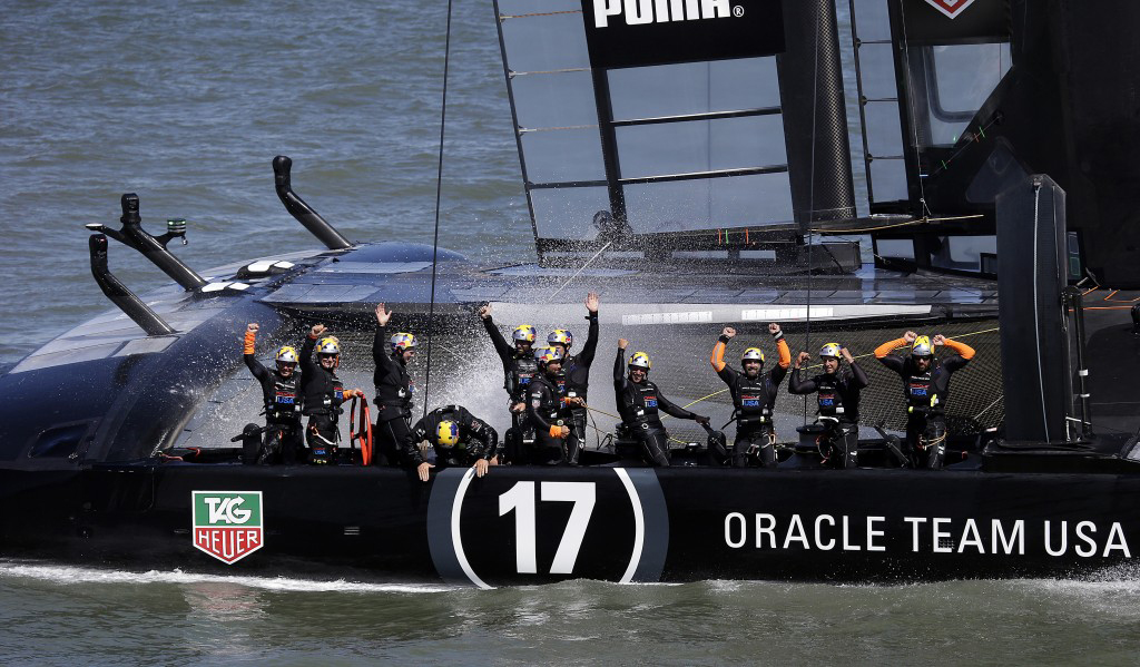 Oracle CEO Larry Ellison with Oracle Team USA after winning the 18th race of the America's Cup sailing event against Emirates Team New Zealand, September 24, 2013, in San Francisco. (AP Photo/Ben Margot)